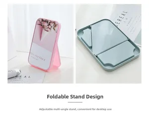 Detail of portable folding makeup mirror showing adjustable stand and floral pink cover