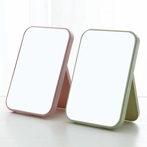 Portable folding desktop makeup mirror in pink and green with adjustable stand