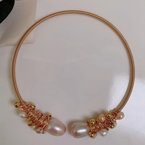 Detail of handmade 14K gold plated wire wrapped collar featuring real freshwater pearls