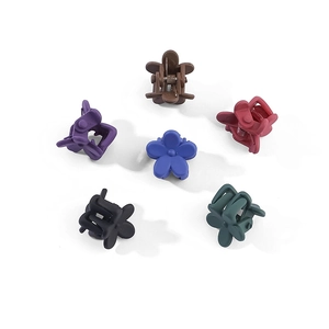 Detail of six colorful matte flower mini hair claws for girls in various shades