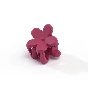 Close-up of a matte rose red flower hair claw clip with interlocking teeth for girls