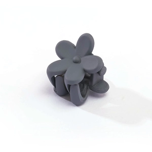 Detailed view of small dark grey matte flower hair claw clip for girls' hairstyles