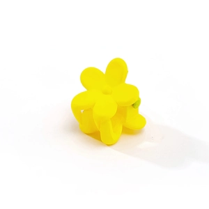 Close-up of yellow matte flower hair claw clip with a frosted resin finish for kids
