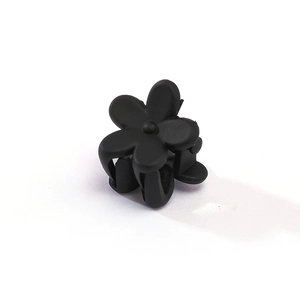 Detailed view of a small matte black flower hair claw clip with five petals for girls