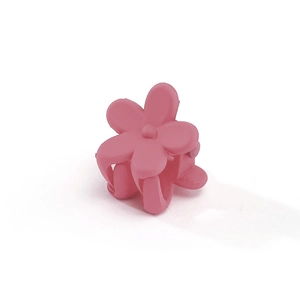 Close-up of matte pink plum blossom hair claw clip made of frosted resin for girls