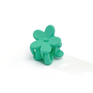 Close-up of a mint green matte flower hair claw clip with a durable resin finish