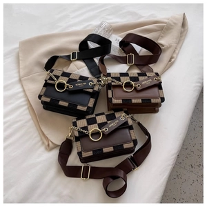 Detailed view of checkered crossbody bags with metallic rings and canvas straps