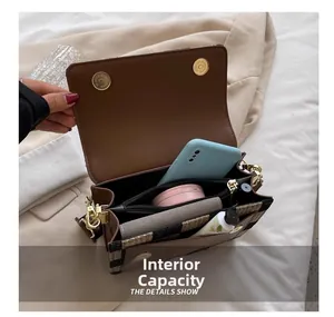 Internal capacity of stylish plaid crossbody bag showing storage compartments