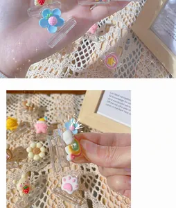 Close-up of cute cartoon resin clips in flower and bear shapes on a lace tablecloth