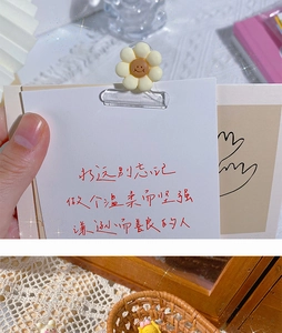 Close-up of a cute yellow flower paper clip on card with aesthetic desktop decor