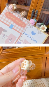 Detailed view of creative cartoon resin binder clips on decorative planner pages