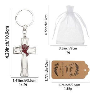 Silver metal cross keychain with peace dove, gift tag, and mesh bag set shown in full