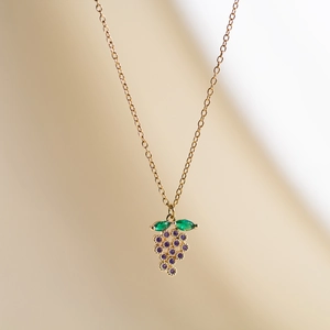 Gold French vintage grape pendant necklace with purple gemstones and green leaves