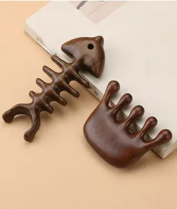 Macro detail of sandalwood dolphin massager and five-tooth scalp comb set on beige book