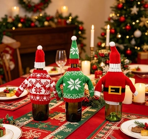 Detailed view of three festive knitted Christmas wine bottle covers with hats