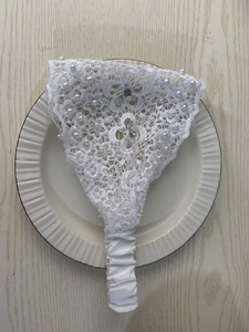 Detail of floral lace headband with pearls and rhinestones on a decorative plate