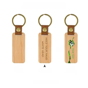 Detail of wooden leather keychains showing wood grain textures and metallic brass ring