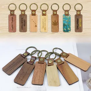 Customized rectangular wooden keychains with brown leather straps and metal rings