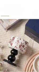 Detail of blue and white porcelain scented candle on a black gourd-shaped stand