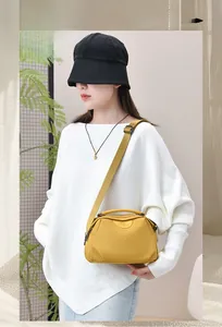 Ginger yellow waterproof oxford handbag shown on model with adjustable strap