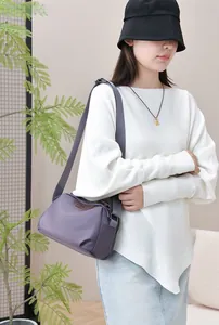 Detail of waterproof nylon purple crossbody bag with adjustable strap on model