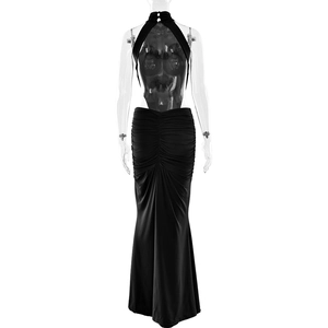 Detail of elegant black backless evening dress featuring halter neck and ruched fishtail hem