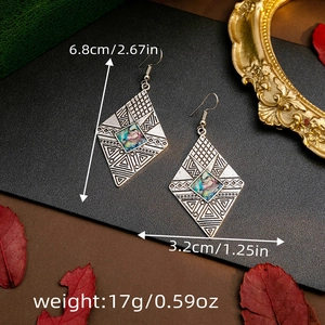 Detailed view of silver bohemian rhombus earrings with size specs and shell inlay details