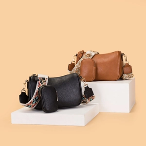 Minimalist faux leather saddle bags in black and brown with colorful wide guitar straps