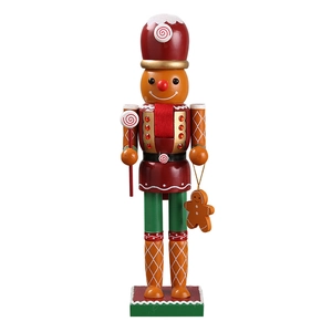 Classic wooden nutcracker soldier with candy ornaments and gingerbread man on a white background