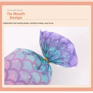 Detail of gradient mermaid scale treat bag with gold tie and secure self-sealing design