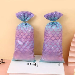 Mermaid scale patterned gift bags with gradient purple and teal colors and gold ties