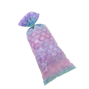 Colorful mermaid scale pattern plastic gift bags with gold twist ties on white background