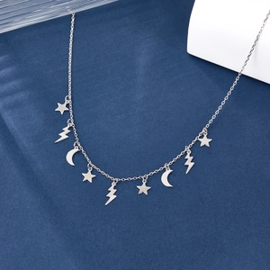 S925 sterling silver necklace with star, moon, and lightning charms on velvet background