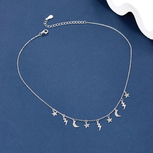 Detail of S925 silver necklace featuring star and moon pendants on a blue background