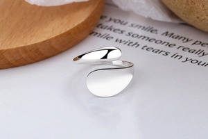 Macro detail of minimalist S925 sterling silver open ring with polished asymmetric design