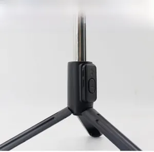 Detail view of the detachable Bluetooth remote on a black tripod selfie stick