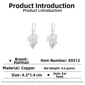 Detail view of silver grape pearl earrings with sparkling zircon accents and hooks