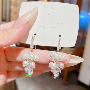 Close-up of elegant pearl and zircon grape cluster drop earrings with silver hooks