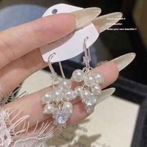 Detailed close-up of grape-shaped pearl earrings with sparkling zircon accents