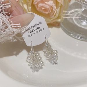 Close-up of 925 silver grape cluster earrings with white pearls and clear crystals