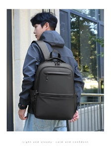 Outdoor shot of a black waterproof business backpack with ergonomic padded shoulder straps