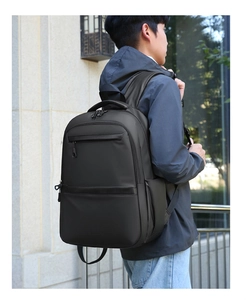 Side view of large black business travel backpack with padded handle and water bottle pocket