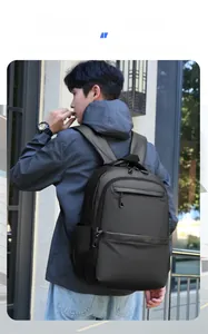 Close-up of black waterproof business backpack with front zipper and side pocket details