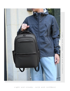Outdoor shot of black large-capacity business backpack with multiple zipper compartments