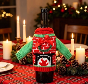 Detail of red and green knitted Christmas wine bottle cover with a red satin bow accent