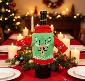 Close-up of knitted Christmas reindeer wine bottle sweater in red and green festive colors