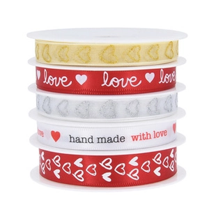 Detailed set of five ribbon rolls with heart patterns and handmade text for bouquet decor