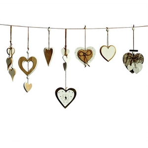 Detailed view of rustic heart-shaped wooden ornaments with hollow designs and twine bows