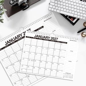 Macro detail of 2027 monthly calendar planner with spiral binding and goal setting sections