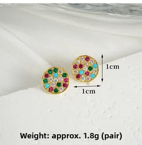 Detail view of 1cm round gold earrings with multi-colored pavé zircons and gemstones